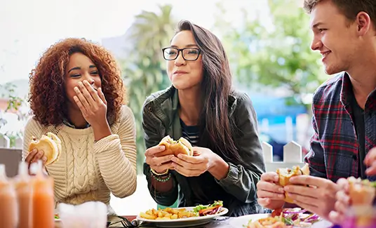 group of young adults enjoying lunch